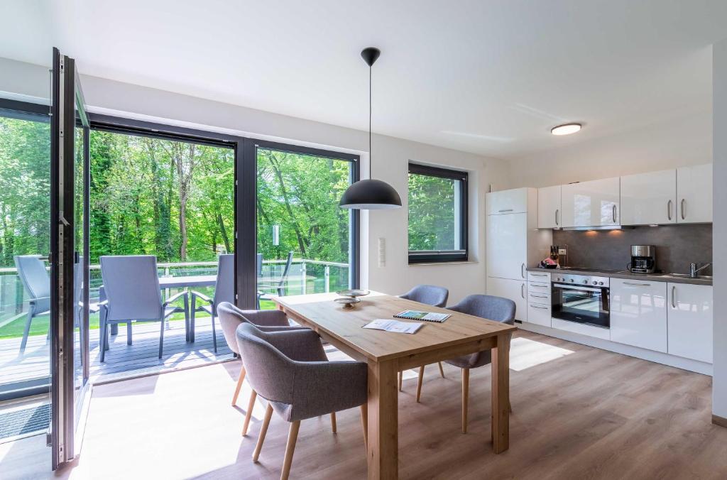 a kitchen and dining room with a table and chairs at Apartment Frau Hummel - Urlaub am Krakower See in Krakow am See