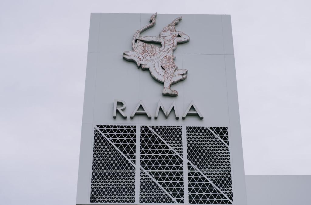 a sign for the kamana building at The Rama Hotel in Chiang Rai