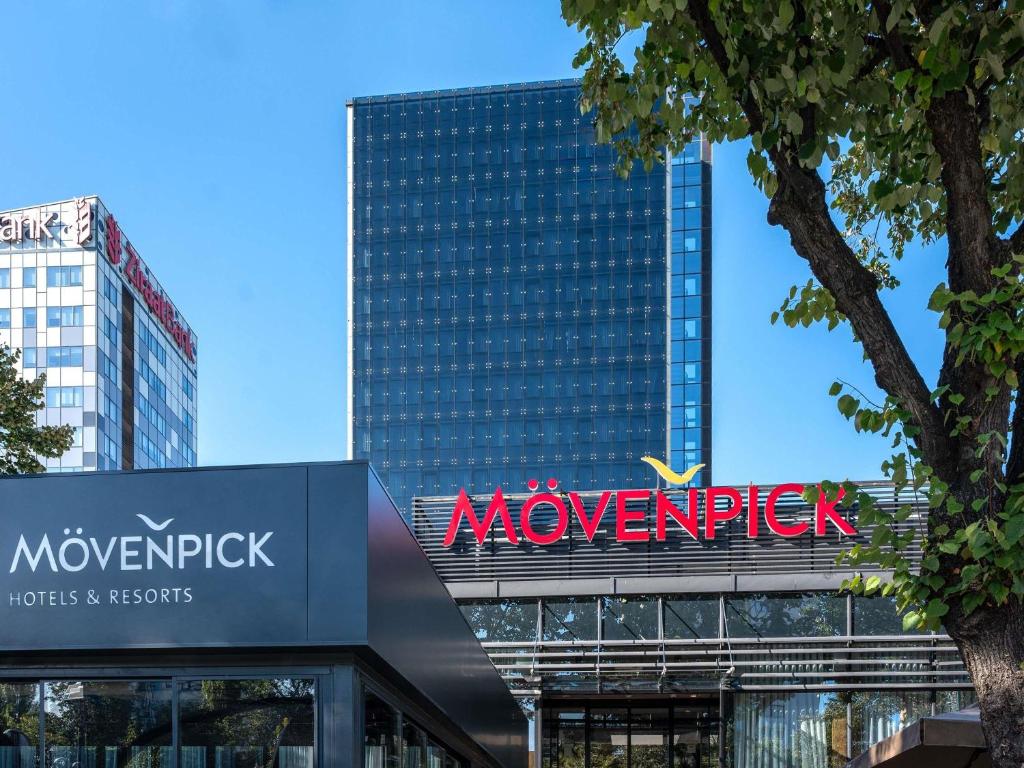 a large skyscraper with a sign in front of it at Movenpick hotel Sarajevo in Sarajevo