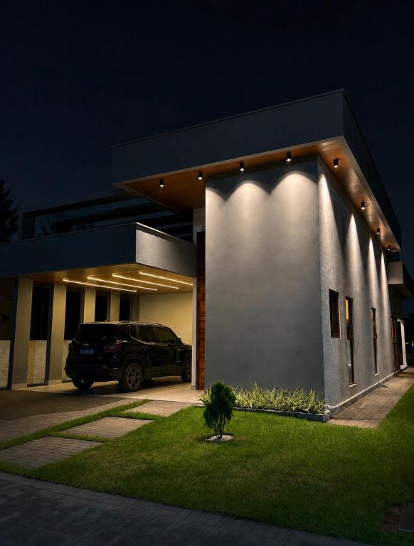 a car parked in front of a building at night at Casa Cerejeiras - Condomínio Privado in Bananeiras