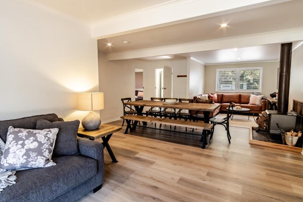 a living room with a couch and a table at Ovens River Retreat in Harrietville