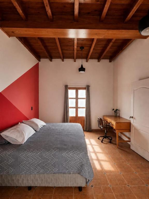 a bedroom with a large bed and a desk at Loft Juárez in Amecameca de Juárez