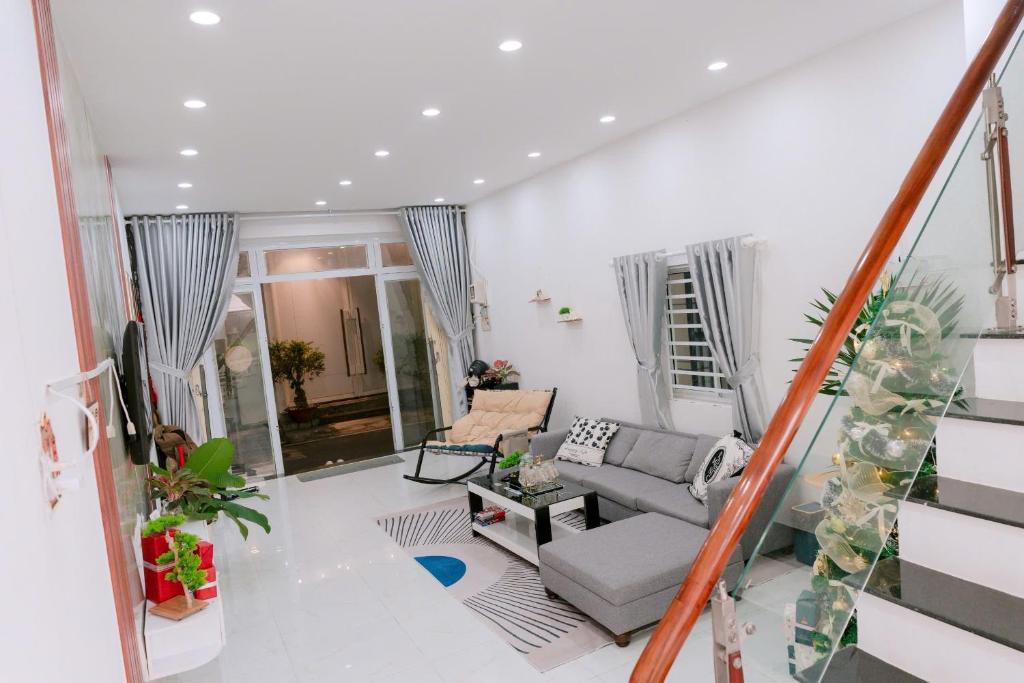 a living room with a couch and a table at HeavenVilla in Can Tho