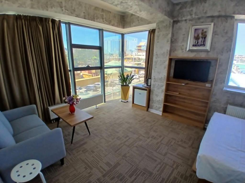 a living room with a couch and a tv at Gandan Peace Guest House in Ulaanbaatar