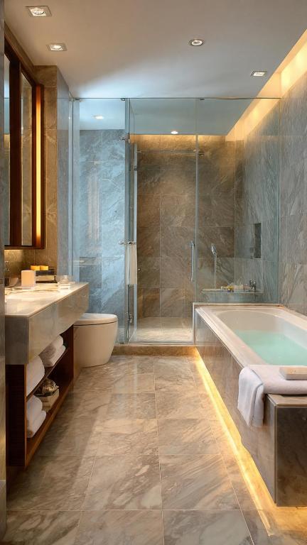 a bathroom with a tub and a sink and a shower at Komodo Island in Ruda