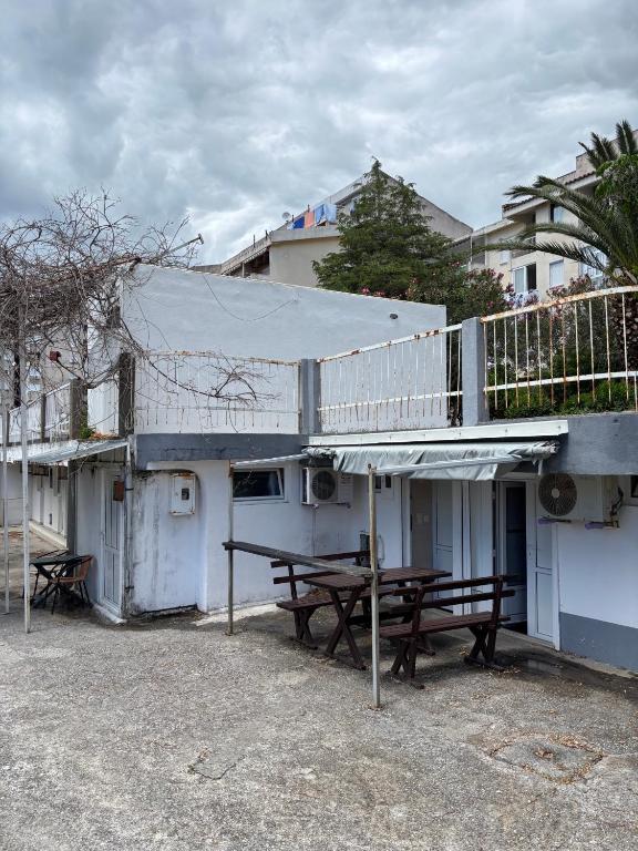 a building with a picnic table and a balcony at Hostel Marina in Sutomore