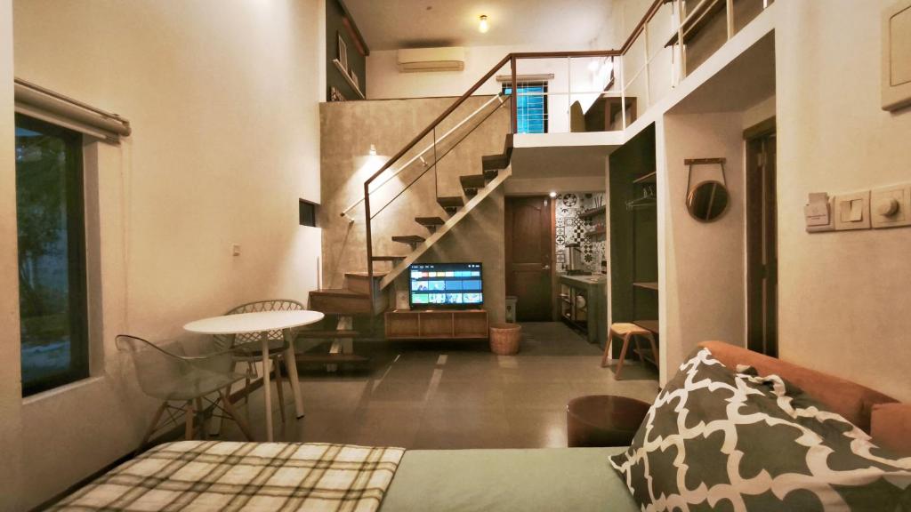 a living room with a bed and a staircase at Cozy & Spacious 2BR Private House in Siem Reap