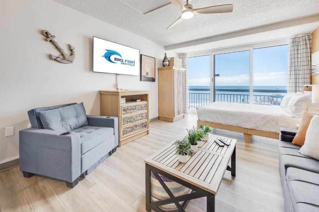 a living room with a couch and a bed and a table at Amazing Large Private Studio Condo with Amazing View in Myrtle Beach