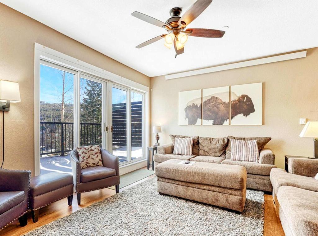 a living room with a couch and a ceiling fan at Crestview Place Mountain View Balcony & Shuttle in Winter Park