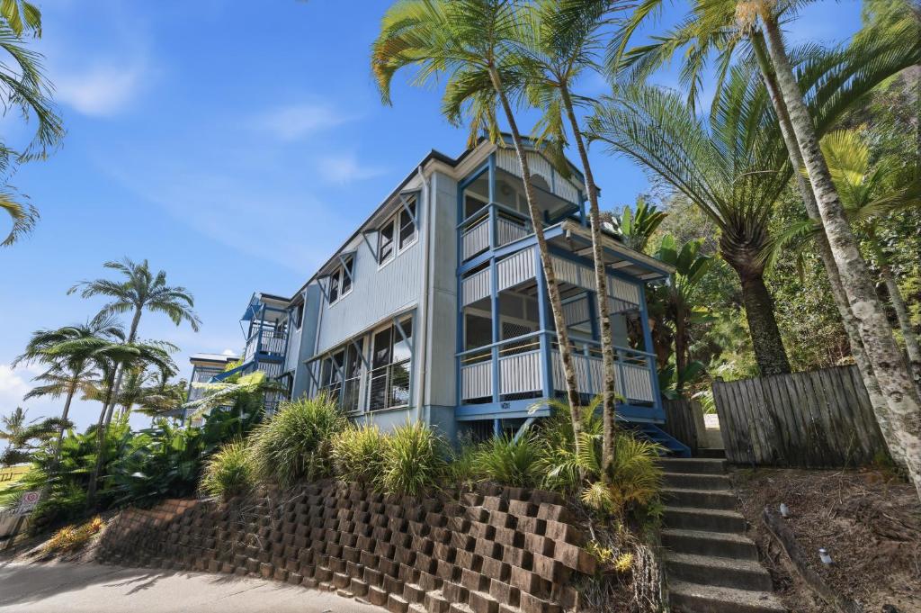 a house on the beach with palm trees at Villa 31 Tangalooma Beach Front in Tangalooma