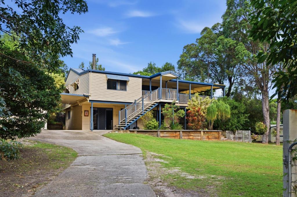 a large house with a porch and a balcony at Quandamooka Beach House in Bulwer