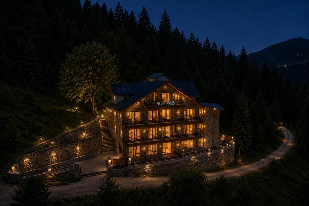 a large building with lights on it at night at The Alpine Escape, Manali - A Beautiful Cottage in Cloud's in Manāli