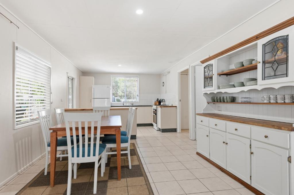 a kitchen and dining room with a table and chairs at Curlew Corner in Cowan Cowan