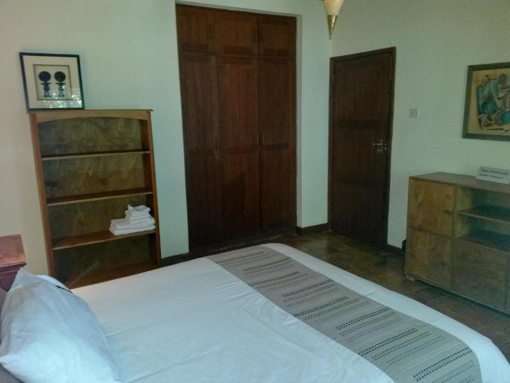Postel nebo postele na pokoji v ubytování Mwanzo Lodge