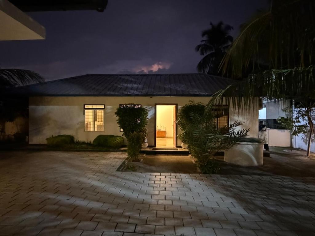 a house at night with the lights on at Triple A Gardens in Kollam