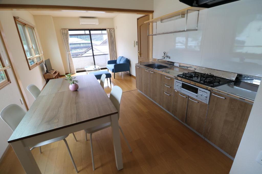 a kitchen with a table and a dining room at 郡上八幡 貸宿 GujoHachiman Kashiyado ICHI in Gujo