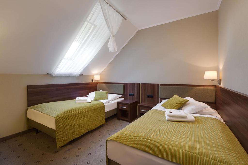 Postel nebo postele na pokoji v ubytování Artus Resort