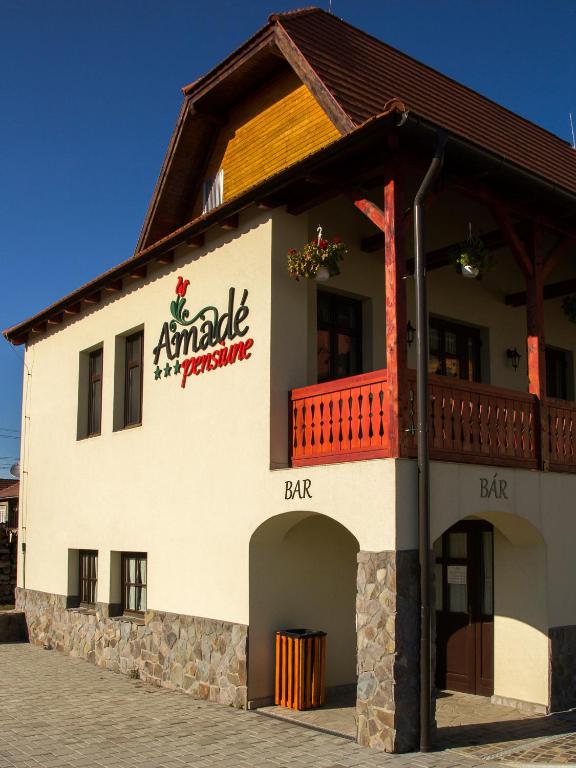 a building with a sign that reads antarctic restaurant at Amadé Pension in Siculeni