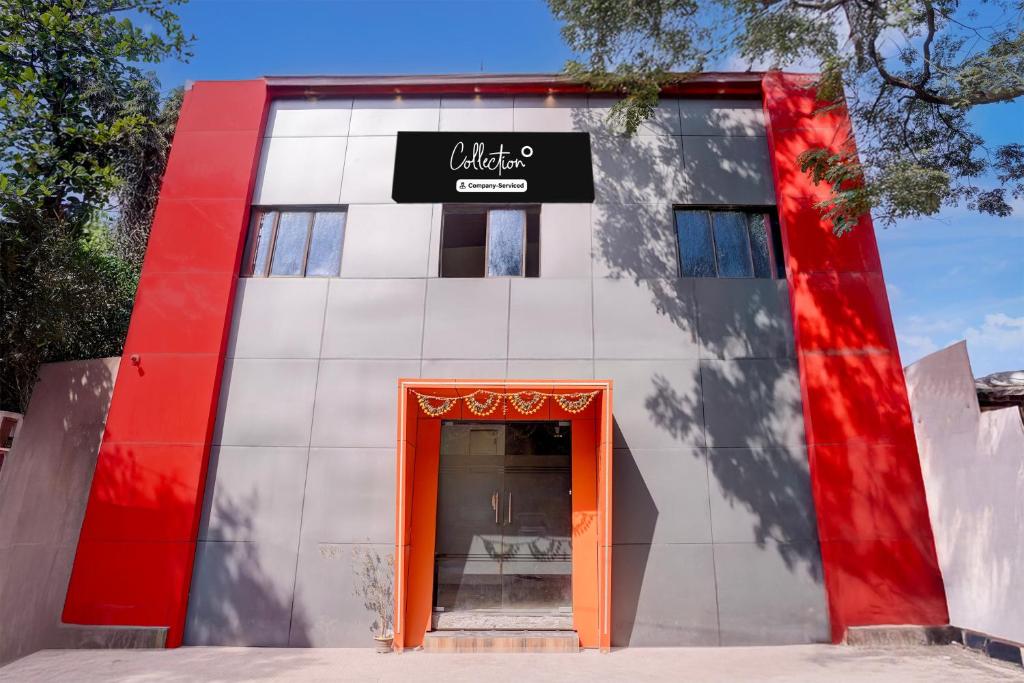 a red and white building with an orange door at Collection O IIM Mumbai Formerly Green View in Mumbai