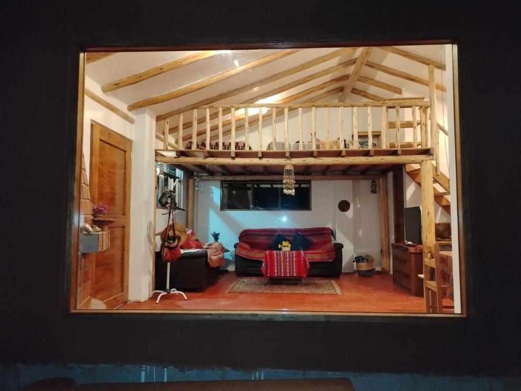 a view of a living room with a loft at Sami Huaypo Cabin in Cheqquerec
