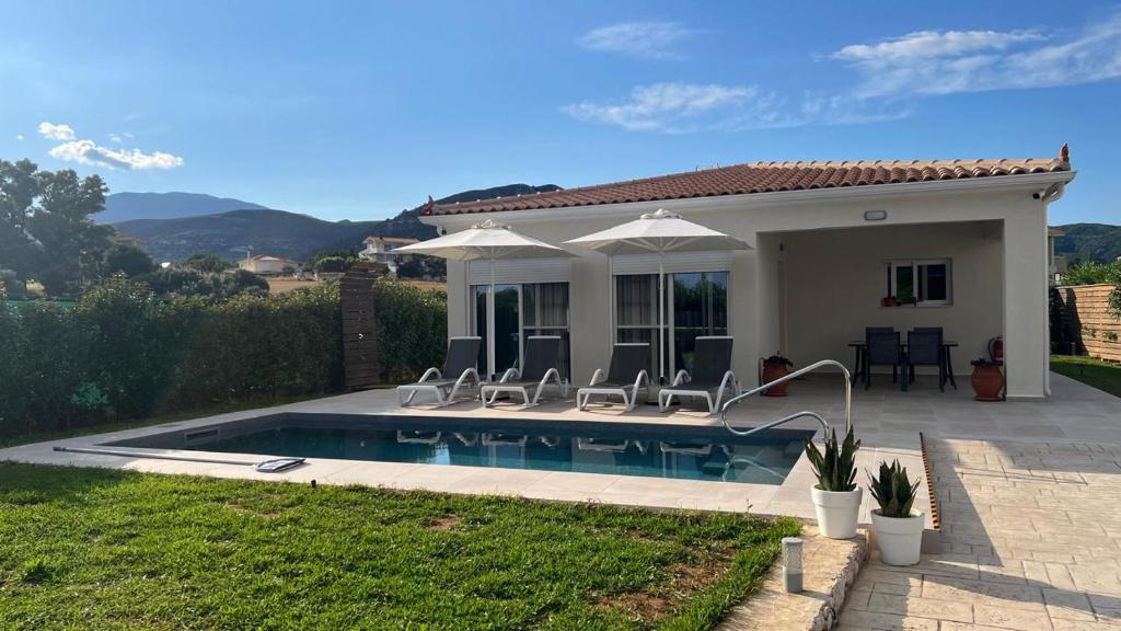 a villa with a swimming pool and a house at Marilena in Skala
