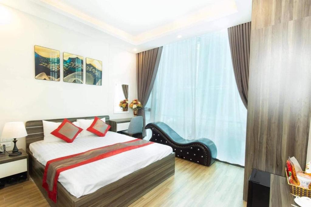 a hotel room with a bed and a chair at Bach Khoa Hotel in Hanoi