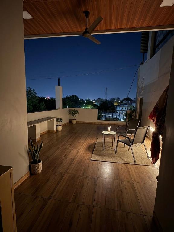 a large balcony with a table and chairs on a roof at Hotel Vasundhara in Garot