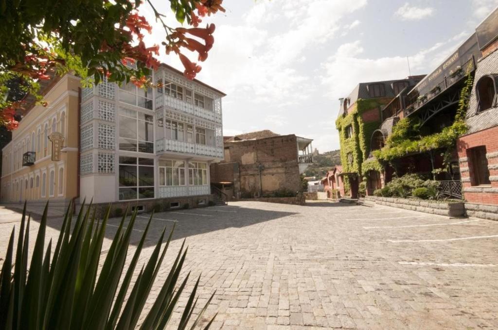 an empty street in an old town with buildings at Guest House Imereti in Tbilisi City