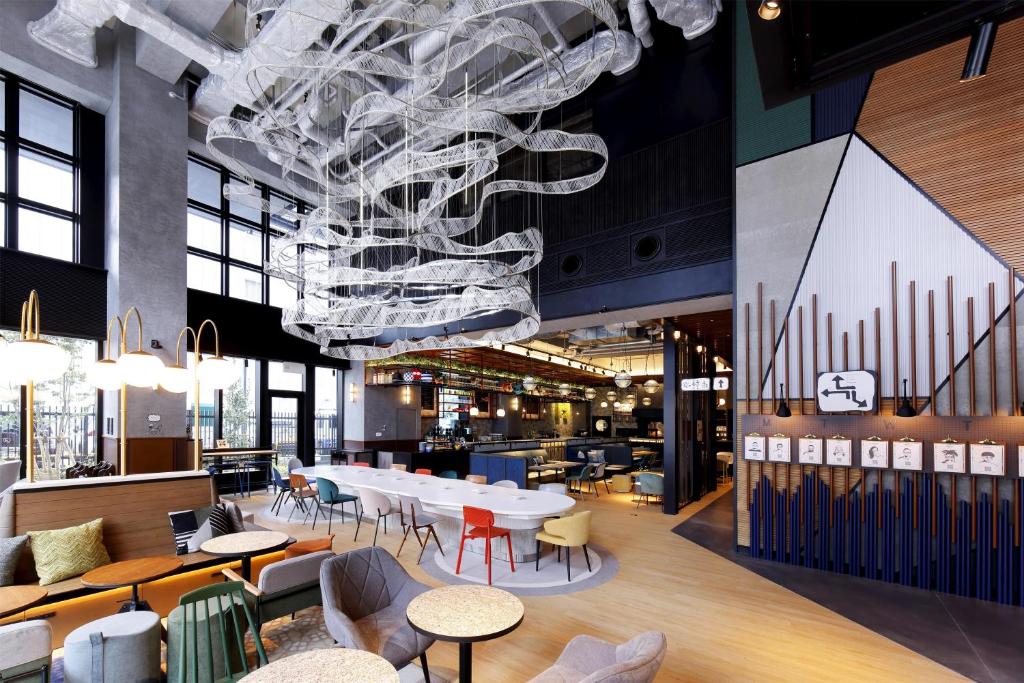 a large dining room with a white table and chairs at Caption by Hyatt Namba Osaka in Osaka