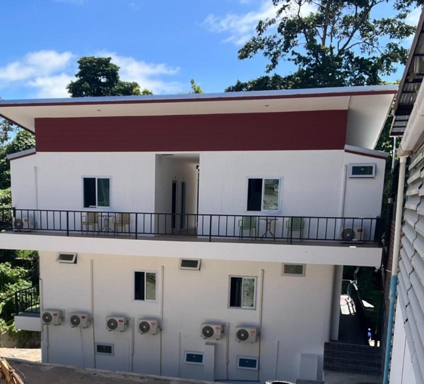 a building with a balcony on top of it at Koh Tao Townhouse in Ko Tao