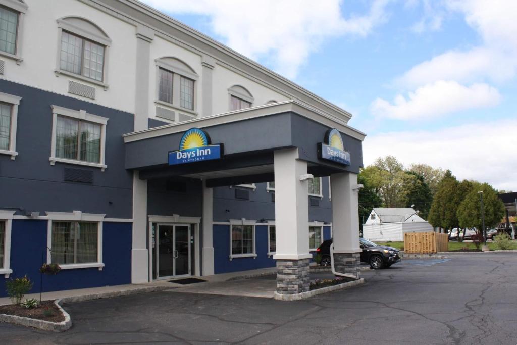 a blue and white building with a sign on it at Days Inn by Wyndham Budd Lake in Budd Lake