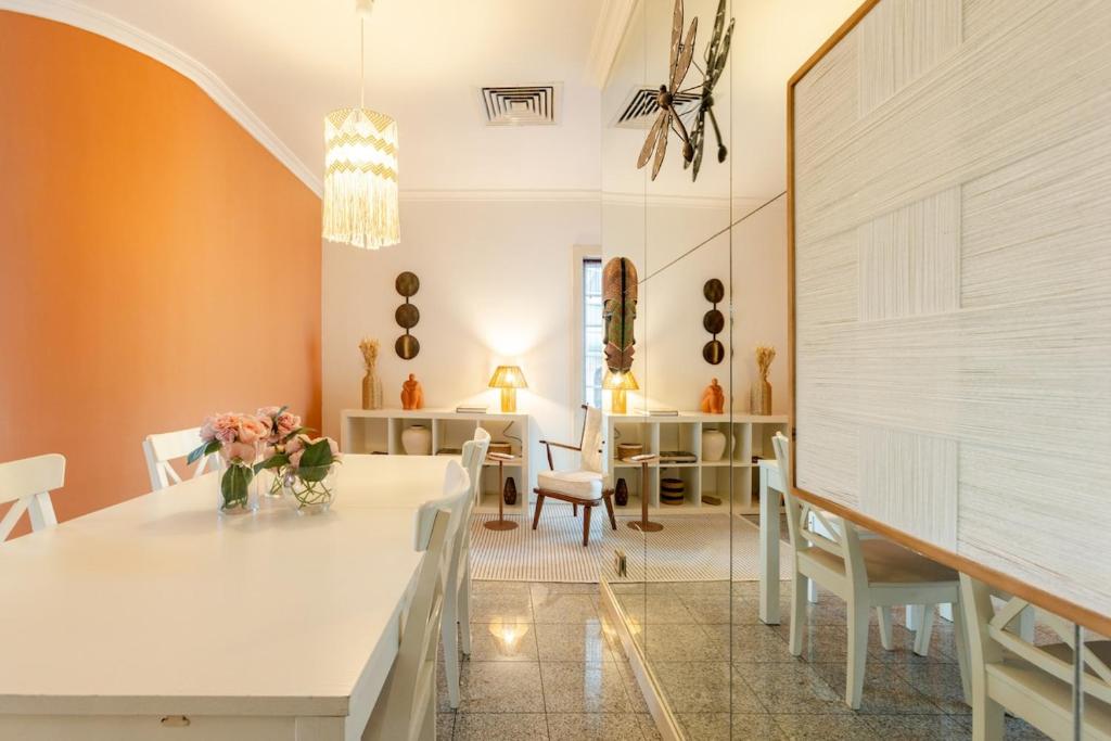 a dining room with a white table and chairs at Casa do Rio in Chaves