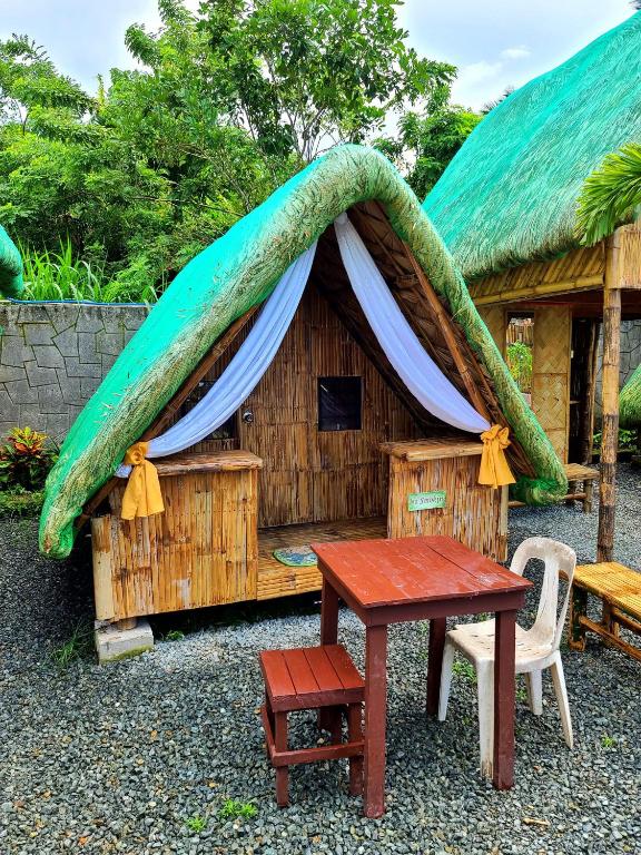 a small house with a surfboard on top of it at Itawis Resort - Nature Chalet in Silang