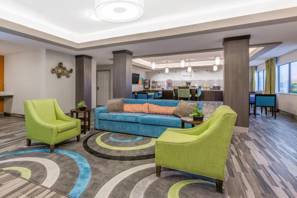 a living room with a couch and chairs at Days Inn & Suites by Wyndham Katy in Katy