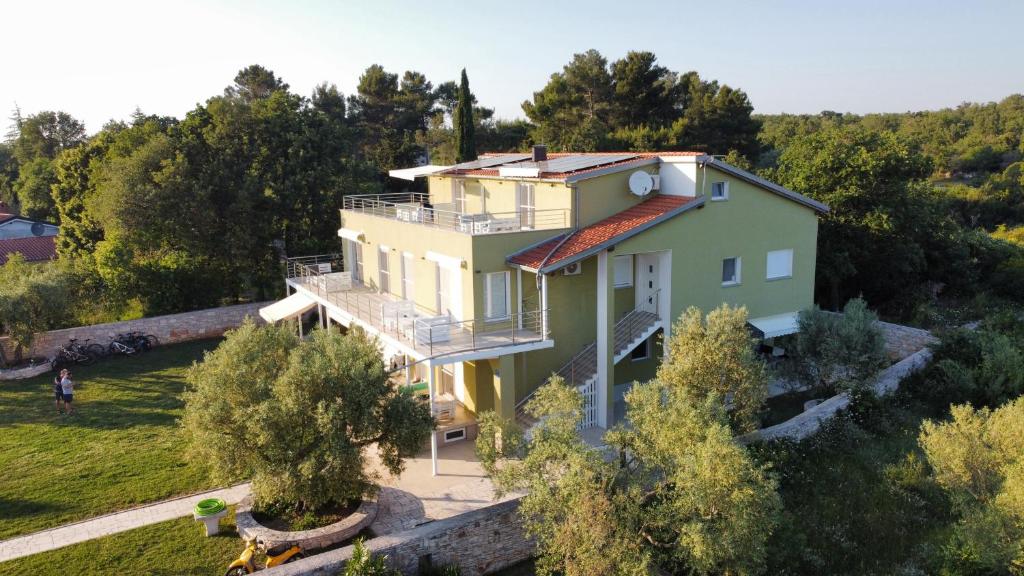 an aerial view of a house with trees at Apartments Nogic in Peroj