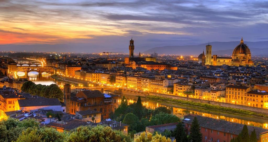 a view of a city at night at Appartamento San Pietro Firenze in Florence