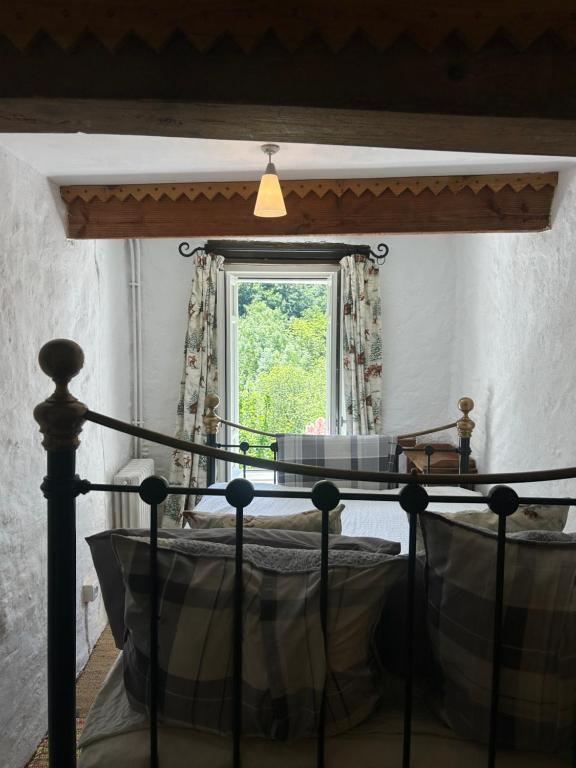 a bedroom with a bed and a window at Maison SItta in Montferrier