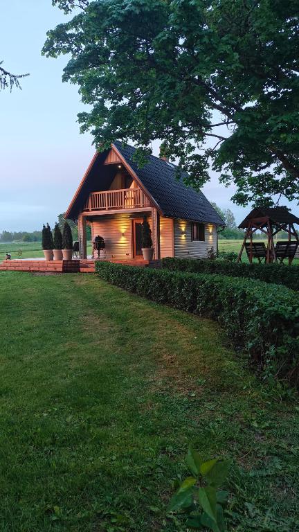 a house with a gambrel roof and a yard at Supsi Saun in Supsi