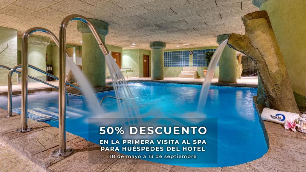 a pool at a hotel with a water slide at Senator Granada in Granada