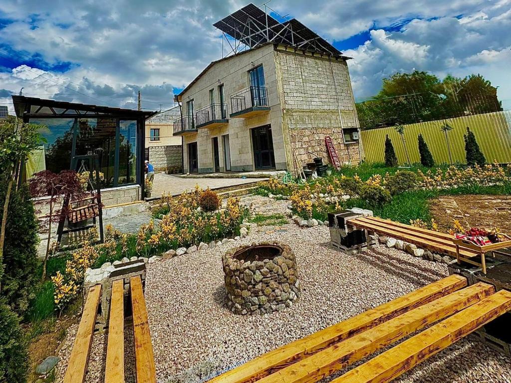 a building with a bench and a building with a windmill at Bee Planet Garni in Garni