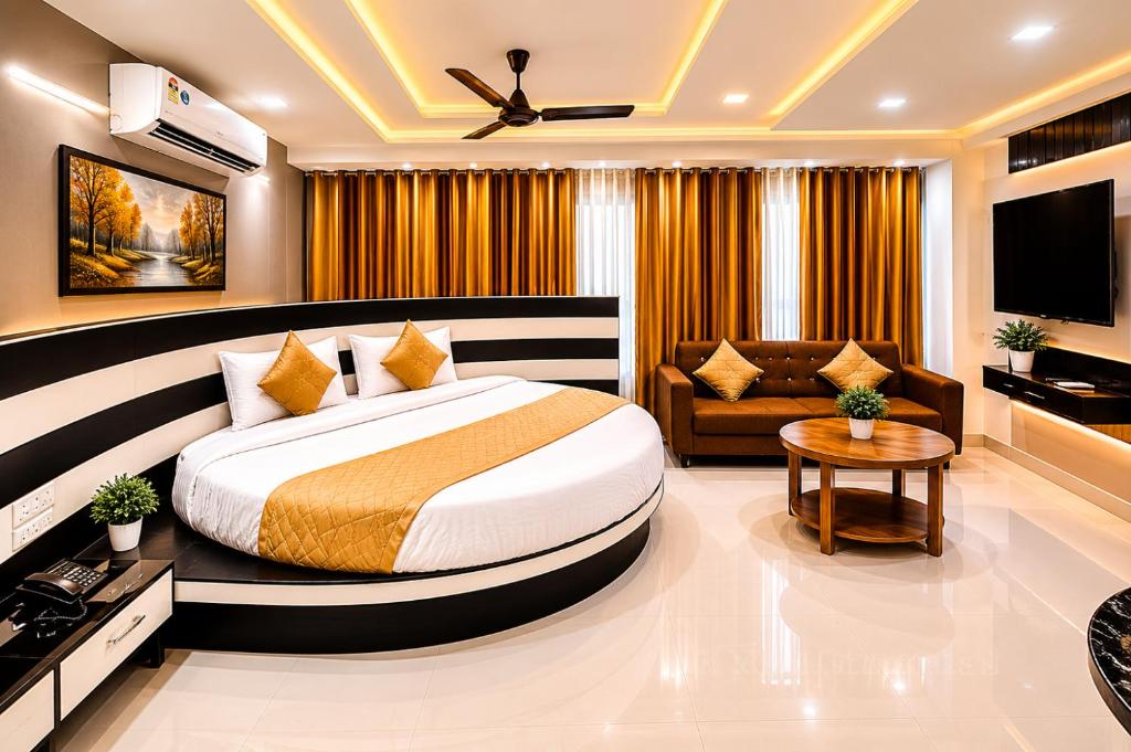 a bedroom with a large bed and a couch at Hotel Apollo Sp Ring Road Odhav Ahemdabad in Ahmedabad