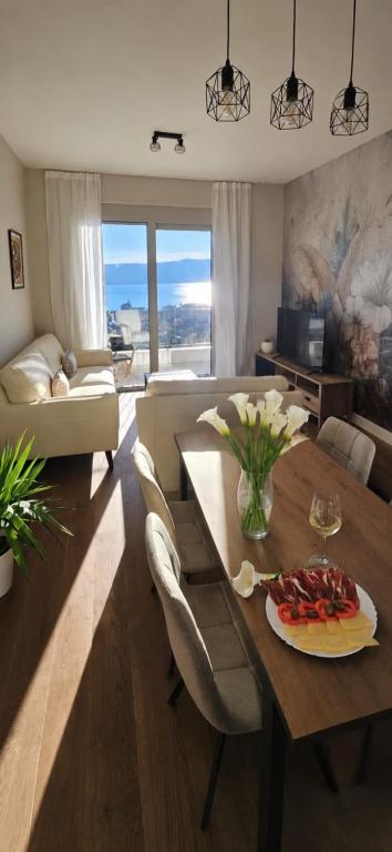 a living room with a table with a plate of food on it at Damisa Lux Stan in Tivat