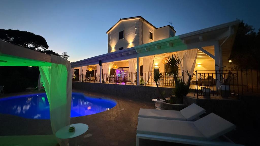 a house with a swimming pool and a building at B&B Borgo del Nespolo in Peschici
