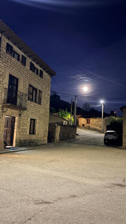 a car parked next to a building at night at Los Quejigares in Terradillos de Sedano