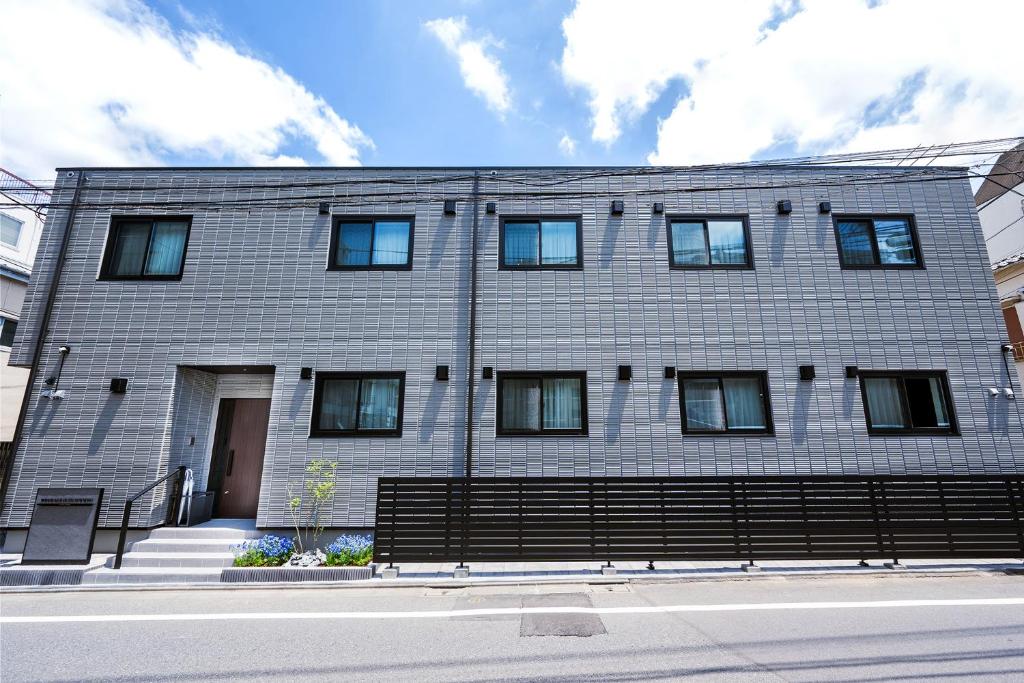 a large brick building on a street at WANOKAEDE HOTEL New Wing in Tokyo