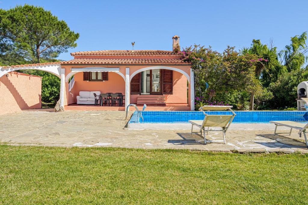 a villa with a swimming pool and a house at Villa Rosa in Olbia