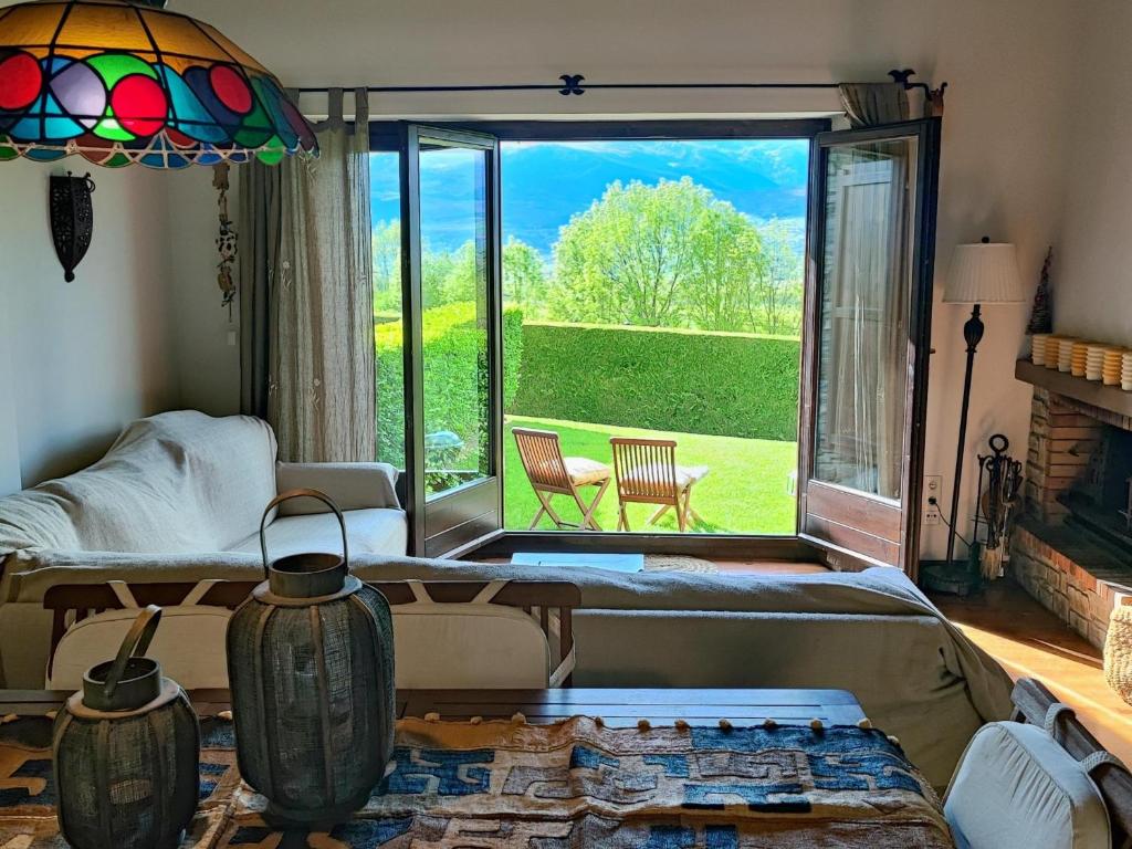 a living room with a large window with a view at Casa Adosada en Alp Jardin y Wifi in Alp