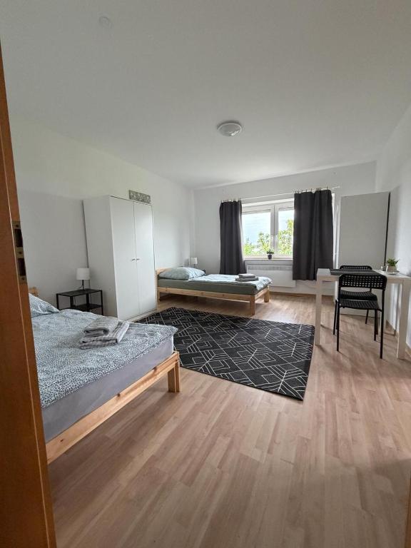 a bedroom with two beds and a living room at Deichnest in Hollern-Twielenfleth