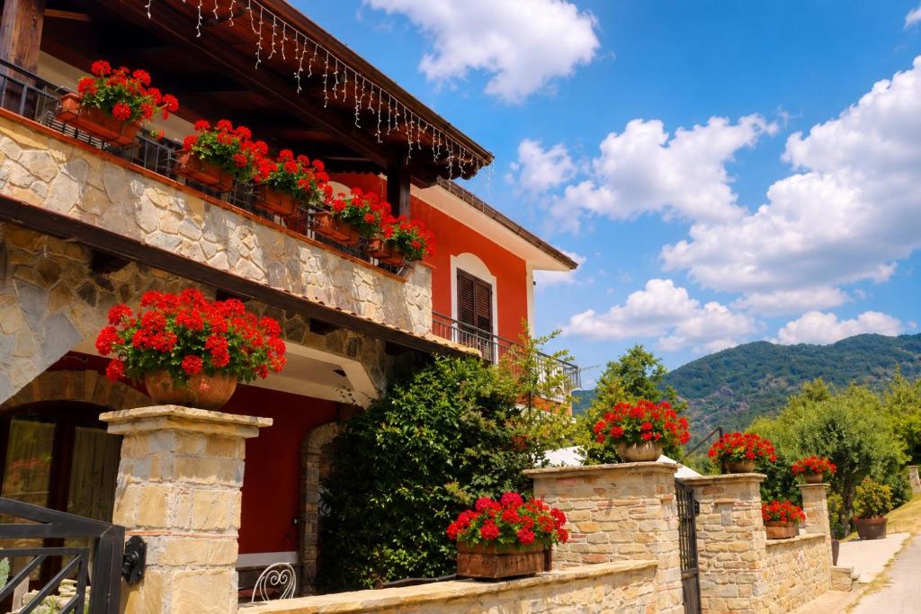 a building with flowers on the side of it at Villa Manca in San Severino Lucano