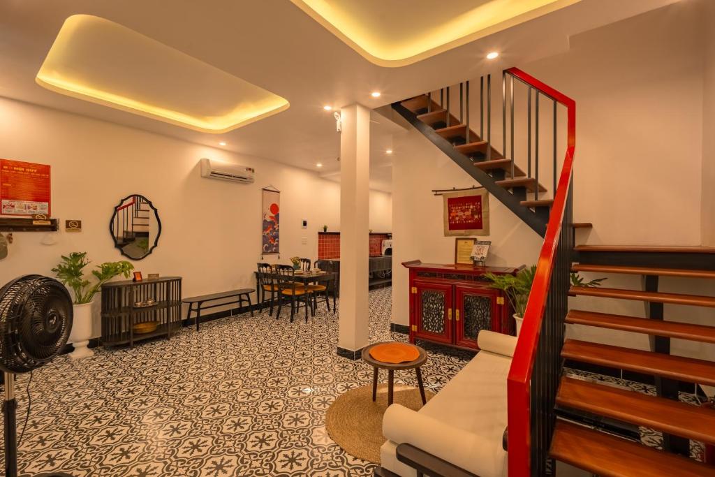 a lobby with a staircase and a living room at Bao An Home old Town in Hoi An